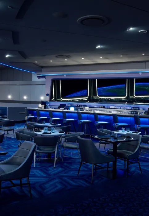 The dining room of a spaceship with blue lighting.